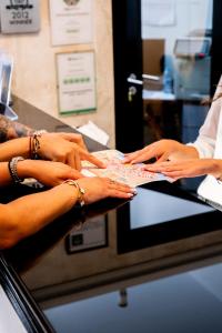 a group of four women getting their hands on a table at Hotel Puerta del Mar - Adults Recommended in Nerja +37 photos