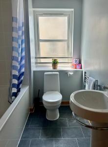 a bathroom with a toilet and a sink and a window at The Inver Nest in Inverness +6 photos