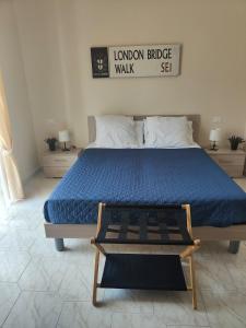 a bedroom with a large bed with a blue comforter at Hyria Intero Appartamento in centro città in Avellino