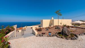a view of a house with a rock garden at Aronia Glow Villa in Imerovigli