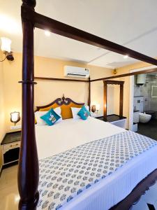 a bedroom with a large bed with a wooden headboard at Diwan House in Agra