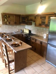 a kitchen with wooden cabinets and a table with bowls on it at Chata Pod Grapom in Czarna Góra