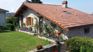 a stone house with a red tile roof at Le Grangeon 01 in Ambérieu-en-Bugey