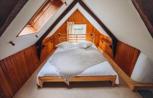a bedroom with a bed in a attic at Lodge Kervoazec - Château de Kervoazec in Saint-Goazec +34 photos