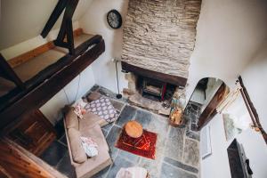 an overhead view of a living room with a stone fireplace at Lodge Kervoazec - Château de Kervoazec in Saint-Goazec