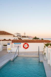 a swimming pool in front of a building at Hotel Puerta del Mar - Adults Recommended in Nerja