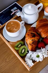 a tray with a plate of food and a cup of coffee at Hotel Puerta del Mar - Adults Recommended in Nerja
