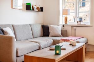 a living room with a couch and a coffee table at Kurnkoomer in Alkersum
