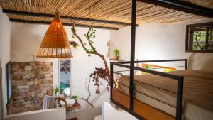 a bedroom with a bed and a lamp in a room at Four Trees Jungle Lodge in San Juan del Sur +57 photos