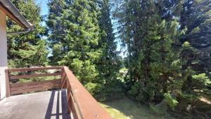 a balcony with a view of a forest of trees at Les balcons du Haut-Forez in Chalmazel Jeansagniere