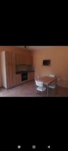 a dining room with a table and two chairs at Casa paradise in San Nicolò