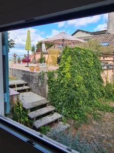 a view from a window of a patio with stairs at Le Jardin Secret in Monflanquin