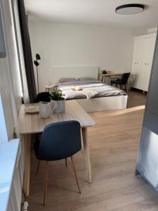 a room with a table and a bed and a bedroom at Center Studio type Apartment in Jelgava