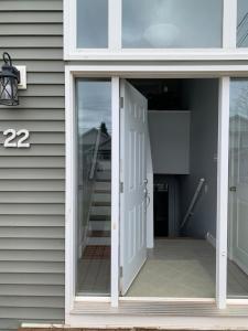 an open door on a house with a porch at Peaceful Stratford Home Bed and Breakfast - 2 BR Lower Level in Stratford