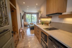 a kitchen with a sink and a counter top at East Blue Luxury Apartment in Kamári