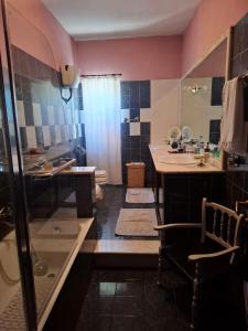 a bathroom with a shower and a sink and a toilet at La Casa di Piero in SantʼAngelo +8 photos