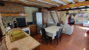 a kitchen and living room with a table and chairs at La fertÉ in Olizy