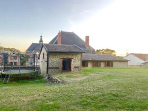 an old stone house with a trampoline in a yard at La fertÉ in Olizy