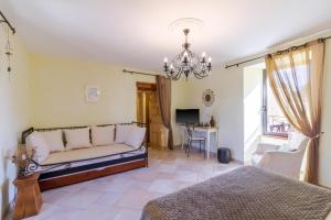 a living room with a couch and a table at Chambre d'hotes Les Clauzels in Proissans