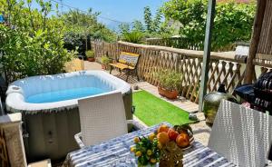 a backyard with a hot tub and a table with fruit at The Dream in Massa Lubrense
