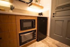a kitchen with a microwave and a dishwasher at East Blue Luxury Apartment in Kamári +14 photos