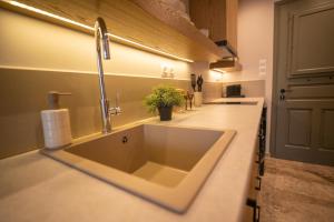 a kitchen with a sink and a faucet at East Blue Luxury Apartment in Kamári