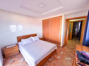 a bedroom with a bed and a wooden cabinet at L'unico - Sea View, Pool & Jaccuzi in Oued Laou +16 photos