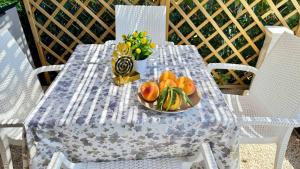 a table with a bowl of fruit and a vase of flowers at The Dream in Massa Lubrense