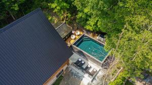 an overhead view of a house with a swimming pool at The ANIMAL - PARTY TIME - POOL SPA AND MOUNTAIN in Saint-Philémon