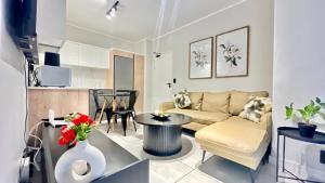 a living room with a couch and a table at 745@TheBlyde in Pretoria