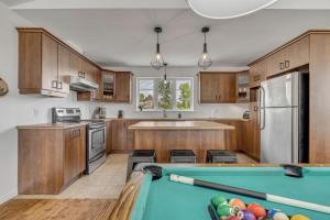 a kitchen with a pool table in the middle of it at Initial - Jumeau 33 - MSA in Saint-Férréol-les-Neiges