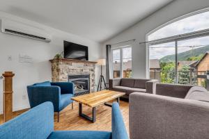 a living room with couches and a fireplace at Initial - Jumeau 33 - MSA in Saint-Férréol-les-Neiges
