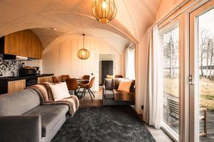 a living room with a couch and a dining room at Apukka Resort in Rovaniemi