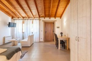 a bedroom with a bed and a desk and a table at Apartamento Pescadeira de Agar in Rego de Santa Marina