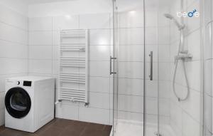 a washing machine in a bathroom with a shower at BEGE APARTMENTS HushStay in Marl