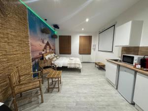 a kitchen and a bedroom with a bed in a room at Bahana Bay in Tourcoing