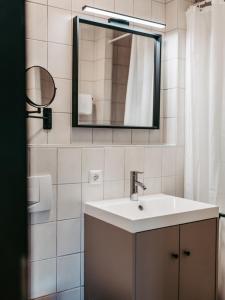 a bathroom with a sink and a mirror at Hotel Gasthof Kern in Halfing