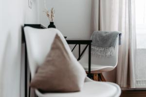 a room with a chair and a table and a window at Hotel Gasthof Kern in Halfing +72 photos