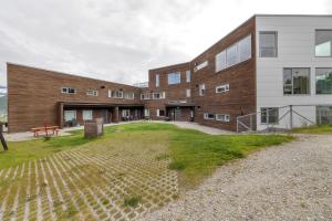 ein Gebäude mit einem Rasen davor in der Unterkunft Northstay - Tromsø Outlook, Amazing City & Mountain Views in Tromsø