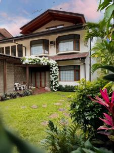 a house with a lawn in front of it at Tropical Lux 5BR Villa Panoramic Isola Bandung in Bandung