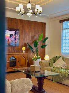 a living room with a couch and a table at Tropical Lux 5BR Villa Panoramic Isola Bandung in Bandung