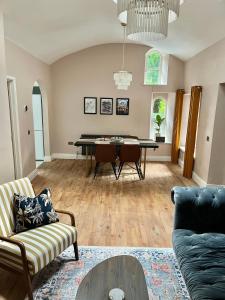 a living room with a table and chairs at Victoria Gate Lodge in Derry Londonderry