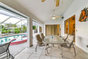 a dining room with a table and chairs next to a pool at Private Dock Waterfront Port Charlotte Oasis! in Port Charlotte
