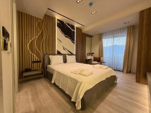 a bedroom with a large bed in a room at Golden Stone Hotel Akçay in Edremit +8 photos