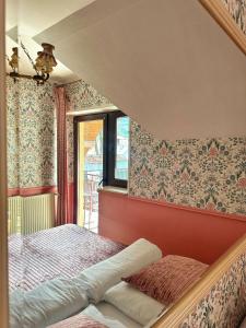 a bedroom with a bed and floral wallpaper at Willa Wydra in Krościenko