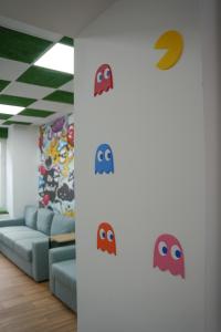 a living room with a couch and some stickers on the wall at Le game clem in Saint-Étienne +10 photos