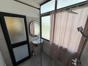 a bathroom with a sink and a mirror and a window at Seaside 2-br flat with terrace in Golem
