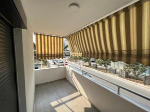 a balcony with large windows and a view of a city at Seaside 2-br flat with terrace in Golem