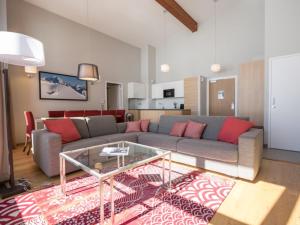 a living room with a couch and a table at Appartement 5 pièces moderne avec piscine, spa, fitness, parking aux Arcs 1800 - FR-1-352-20 in Arc 1800