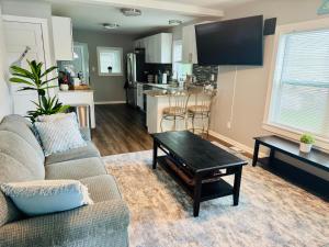 a living room with a couch and a coffee table at Charming Walled Lake MI Cottage in Novi